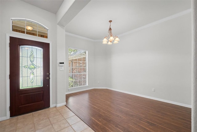 403 Warm Breeze Cv, Austin, TX 78717 - foyer entrance featuring a chandelier, light wood finished floors, and crown molding