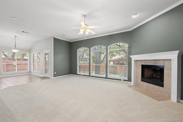 403 Warm Breeze Cv, Austin, TX 78717 - unfurnished living room featuring carpet, ceiling fan, vaulted ceiling, a tiled fireplace, and crown molding