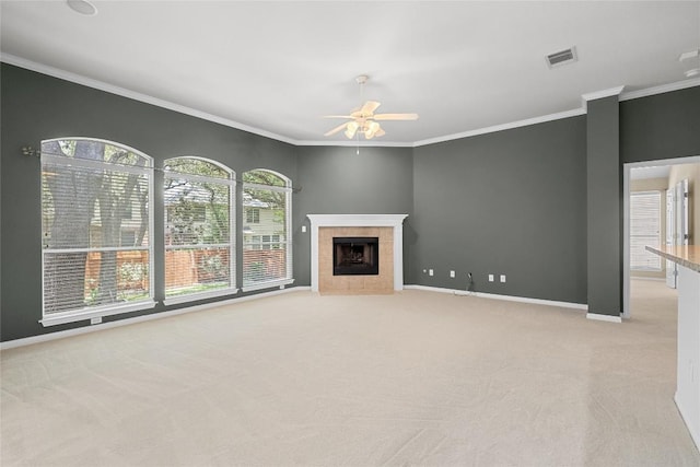 403 Warm Breeze Cv, Austin, TX 78717 - unfurnished living room featuring light colored carpet, ceiling fan, ornamental molding, and a tile fireplace