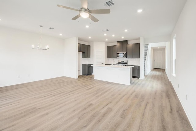 4935 Mozzafiato Ln, Round Rock, TX 78665 - unfurnished living room with light wood-style floors, a ceiling fan, a chandelier, and recessed lighting