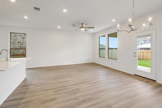 4935 Mozzafiato Ln, Round Rock, TX 78665 - unfurnished living room with light wood-style floors, recessed lighting, a chandelier, and a ceiling fan