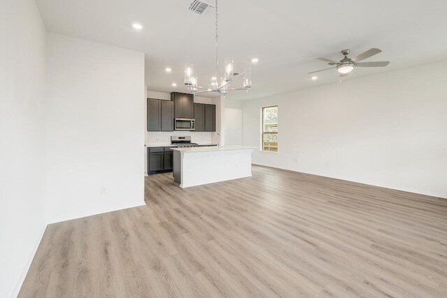 4935 Mozzafiato Ln, Round Rock, TX 78665 - unfurnished living room with a chandelier, recessed lighting, light wood-style flooring, and a ceiling fan