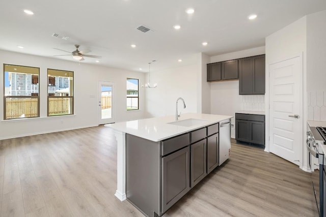 4935 Mozzafiato Ln, Round Rock, TX 78665 - kitchen featuring stainless steel dishwasher, ceiling fan, light wood-style floors, light countertops, and recessed lighting