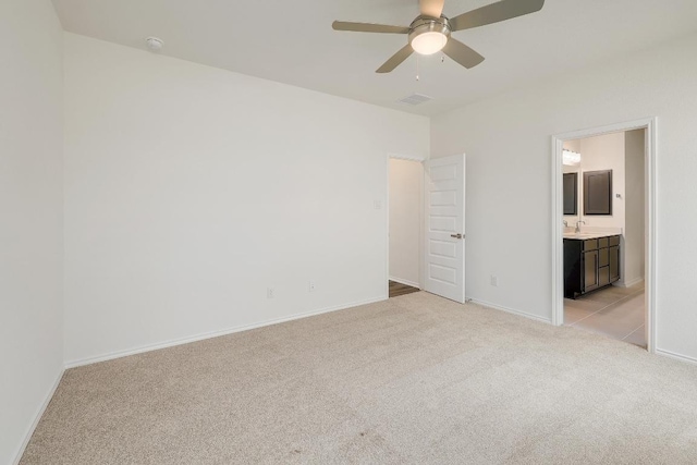 4935 Mozzafiato Ln, Round Rock, TX 78665 - unfurnished bedroom with light carpet, connected bathroom, and a ceiling fan