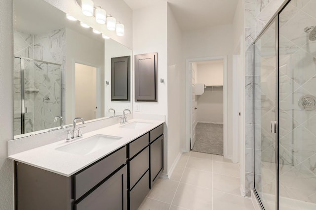 4935 Mozzafiato Ln, Round Rock, TX 78665 - bathroom featuring a spacious closet, a marble finish shower, double vanity, and tile patterned floors