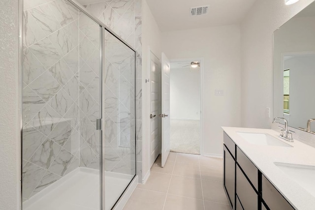 4935 Mozzafiato Ln, Round Rock, TX 78665 - bathroom featuring a marble finish shower, double vanity, and tile patterned floors