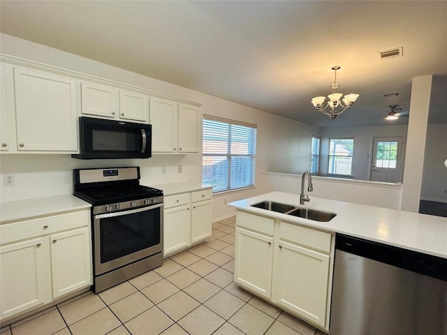 600 Mccarthur Dr, Leander, TX 78641 - kitchen featuring appliances with stainless steel finishes, a chandelier, light tile patterned flooring, and plenty of natural light