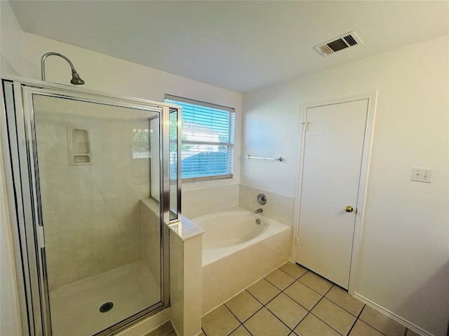 600 Mccarthur Dr, Leander, TX 78641 - full bath featuring a garden tub, tile patterned flooring, and a shower stall