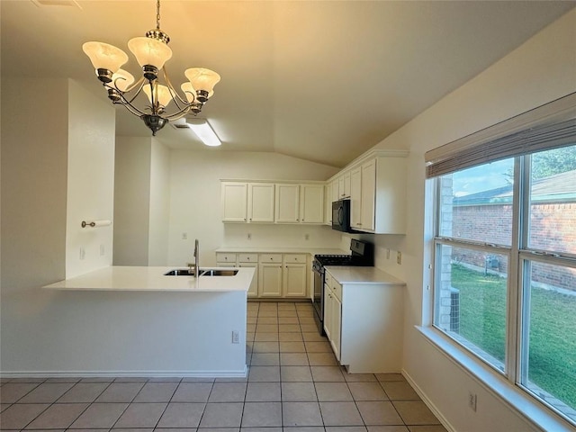600 Mccarthur Dr, Leander, TX 78641 - kitchen with gas range, lofted ceiling, black microwave, light tile patterned floors, and light countertops