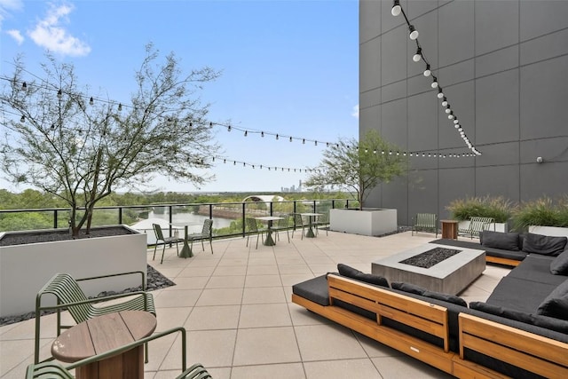1701 Simond Ave Unit 305, Austin, TX 78723 - view of patio featuring an outdoor living space with a fire pit and a water view