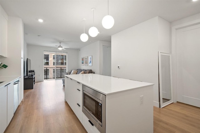 1701 Simond Ave Unit 305, Austin, TX 78723 - kitchen featuring stainless steel appliances, modern cabinets, white cabinetry, light wood-style flooring, and recessed lighting