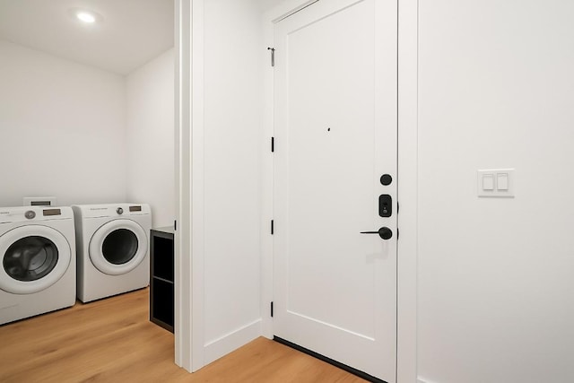 1701 Simond Ave Unit 305, Austin, TX 78723 - laundry room with washer and clothes dryer and light wood-style flooring