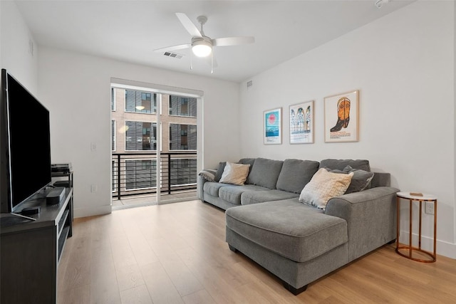 1701 Simond Ave Unit 305, Austin, TX 78723 - living room with light wood finished floors and a ceiling fan