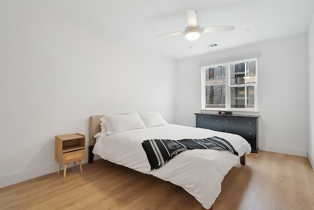1701 Simond Ave Unit 305, Austin, TX 78723 - bedroom featuring light wood-style flooring and a ceiling fan