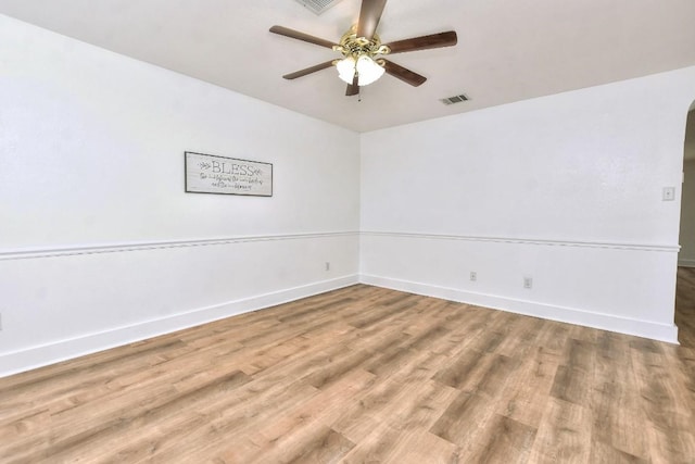 1401 Balsam Way, Round Rock, TX 78665 - unfurnished room featuring wood finished floors, ceiling fan, and arched walkways