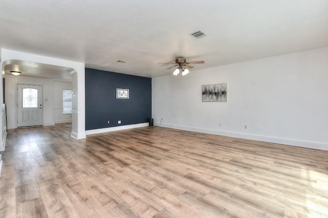 1401 Balsam Way, Round Rock, TX 78665 - spare room featuring arched walkways, ceiling fan, and light wood finished floors