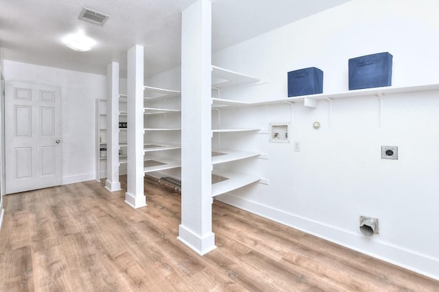 1401 Balsam Way, Round Rock, TX 78665 - laundry area with electric dryer hookup, gas dryer hookup, light wood-type flooring, and washer hookup