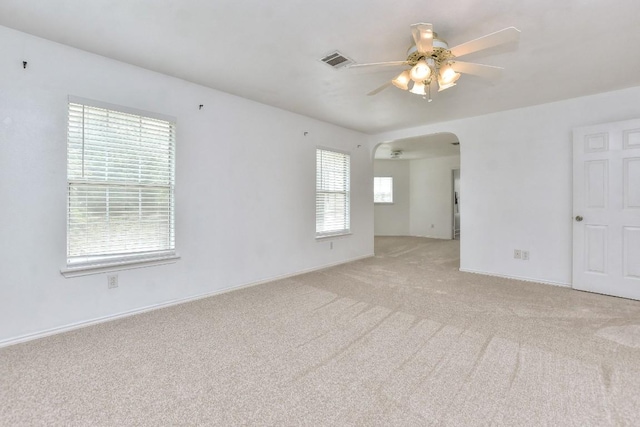 1401 Balsam Way, Round Rock, TX 78665 - spare room featuring a ceiling fan, light carpet, and arched walkways