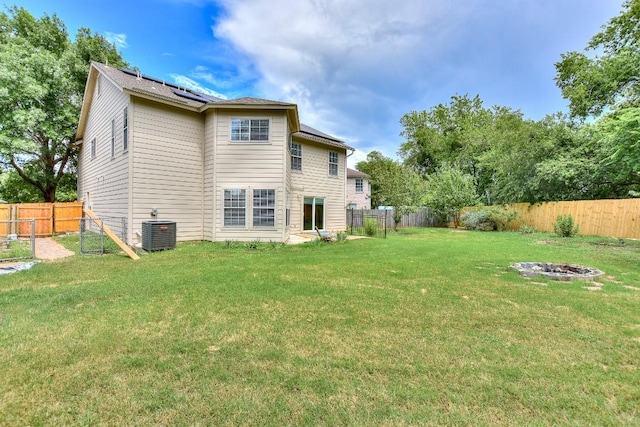 1401 Balsam Way, Round Rock, TX 78665 - rear view of house featuring an outdoor fire pit, solar panels, and a fenced backyard