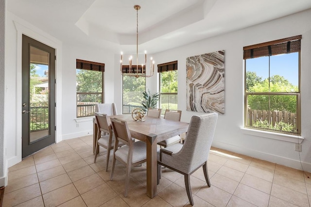 102 Rivulet Ln, Austin, TX 78738 - dining area with a chandelier, light tile patterned floors, plenty of natural light, and a tray ceiling