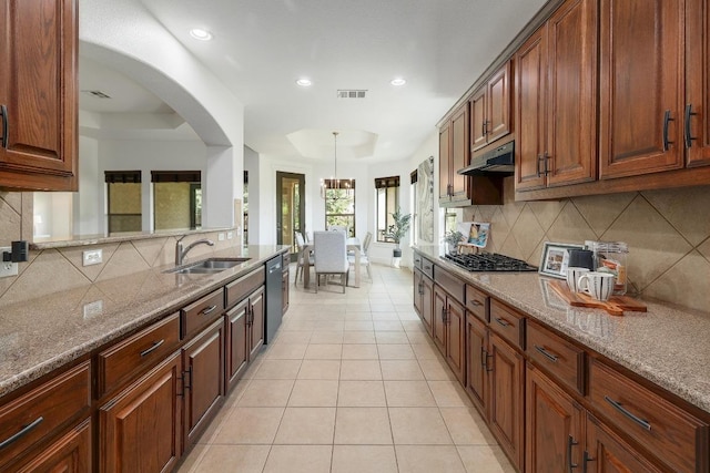 102 Rivulet Ln, Austin, TX 78738 - kitchen featuring backsplash, under cabinet range hood, stainless steel gas stovetop, light stone counters, and recessed lighting
