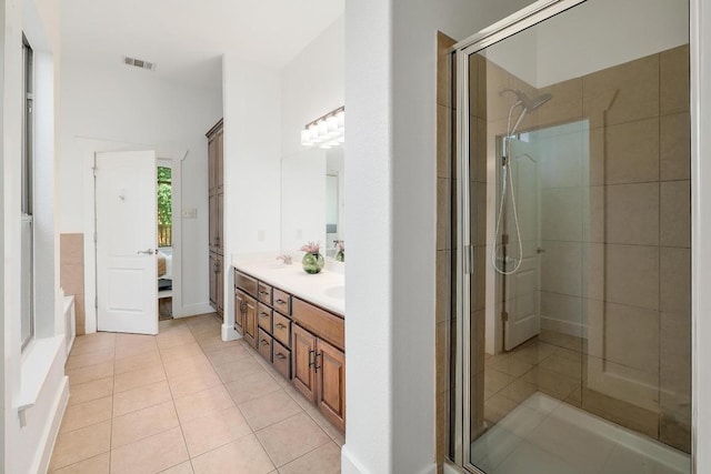 102 Rivulet Ln, Austin, TX 78738 - bathroom featuring double vanity, ensuite bathroom, a shower stall, and tile patterned floors