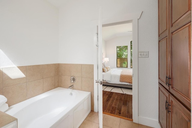 102 Rivulet Ln, Austin, TX 78738 - full bathroom with a bath, connected bathroom, vaulted ceiling, and tile patterned floors