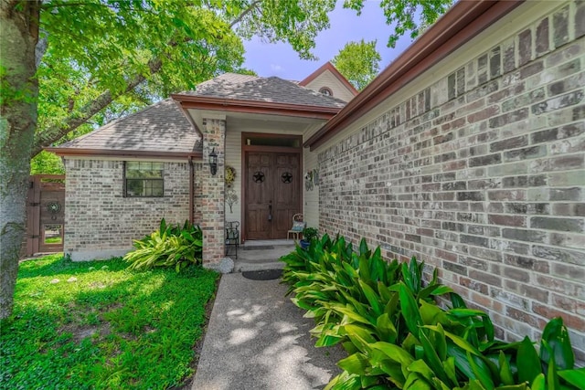 11811 Arabian Trl, Austin, TX 78759 - property entrance featuring a shingled roof and brick siding