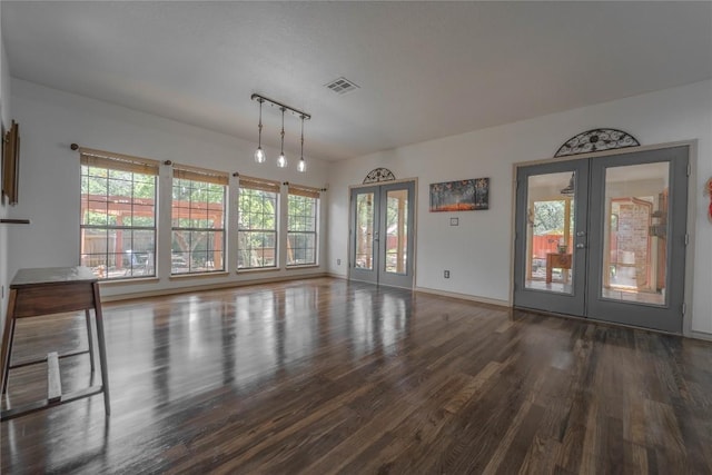 11811 Arabian Trl, Austin, TX 78759 - unfurnished living room with french doors, wood finished floors, and rail lighting