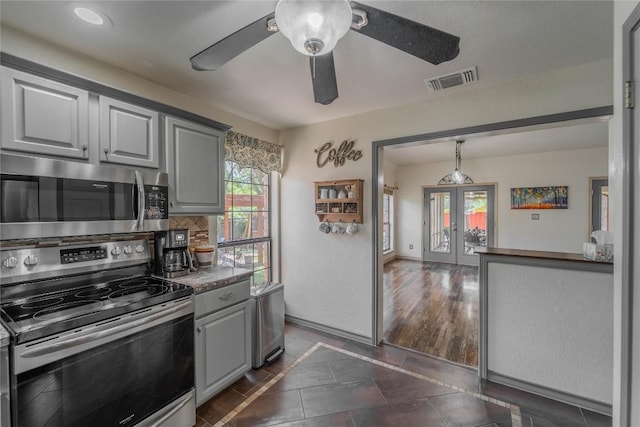 11811 Arabian Trl, Austin, TX 78759 - kitchen with stainless steel appliances, inlaid floor details, gray cabinetry, a ceiling fan, and french doors