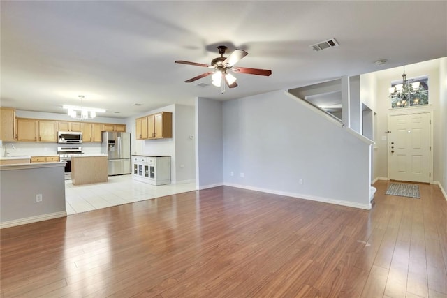 1608 Melibee Trl, Austin, TX 78748 - unfurnished living room with a chandelier, light wood-style flooring, and ceiling fan