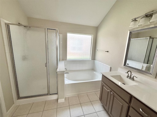 1907 Rutherford Dr, Leander, TX 78641 - full bath featuring vaulted ceiling, a stall shower, vanity, a garden tub, and tile patterned floors