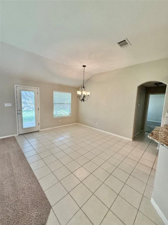 1907 Rutherford Dr, Leander, TX 78641 - unfurnished room featuring light tile patterned floors, arched walkways, lofted ceiling, and a chandelier