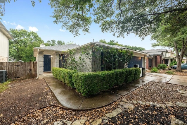 8943 W Hove Loop, Austin, TX 78749 - view of front of house featuring brick siding, a chimney, a garage, and concrete driveway