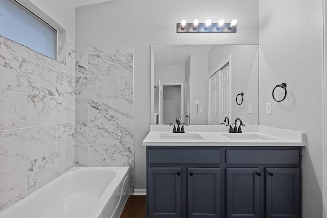 8943 W Hove Loop, Austin, TX 78749 - bathroom featuring double vanity, wood finished floors, and shower / tub combination