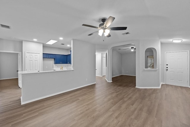 8943 W Hove Loop, Austin, TX 78749 - unfurnished living room with ceiling fan, wood finished floors, and recessed lighting