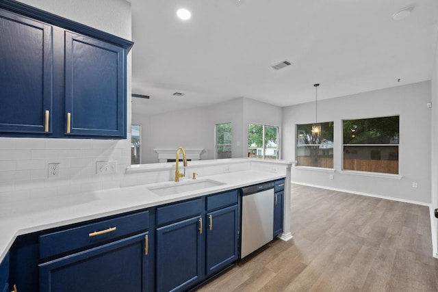 8943 W Hove Loop, Austin, TX 78749 - kitchen with dishwasher, blue cabinets, tasteful backsplash, light wood finished floors, and light countertops