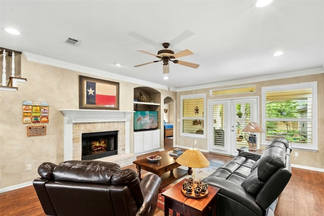 5100 Hadle Cv, Austin, TX 78730 - living area with a ceiling fan, dark wood-style flooring, a brick fireplace, ornamental molding, and recessed lighting