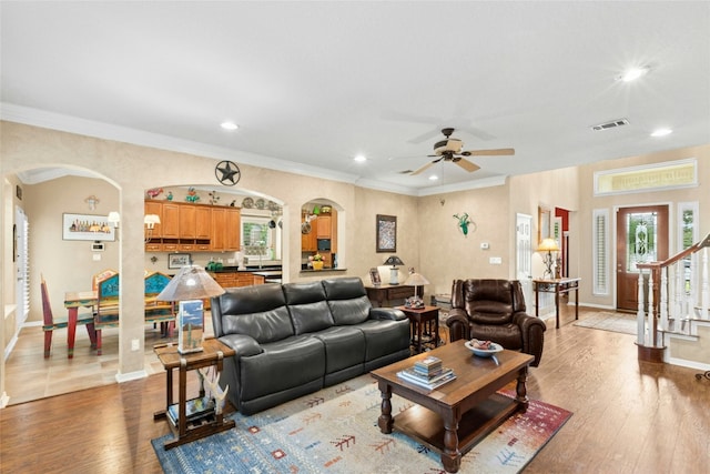 5100 Hadle Cv, Austin, TX 78730 - living area with arched walkways, recessed lighting, ornamental molding, ceiling fan, and wood finished floors
