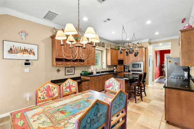 5100 Hadle Cv, Austin, TX 78730 - kitchen with stainless steel appliances, a chandelier, ornamental molding, recessed lighting, and light tile patterned floors