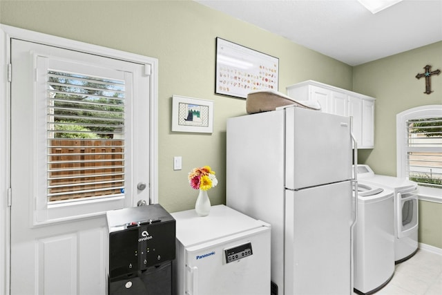 5100 Hadle Cv, Austin, TX 78730 - washroom featuring cabinet space, washing machine and clothes dryer, and light tile patterned floors