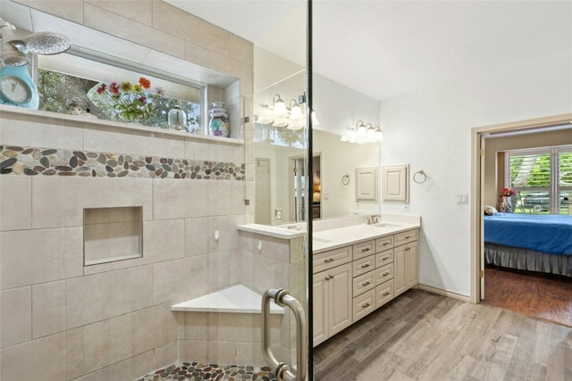 5100 Hadle Cv, Austin, TX 78730 - ensuite bathroom with wood finished floors, double vanity, and tiled shower