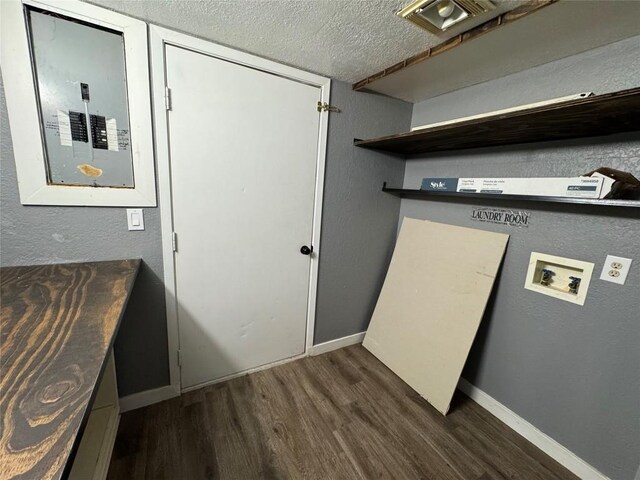 572 Eastern Ave, Bertram, TX 78605 - laundry room featuring electric panel, washer hookup, dark wood finished floors, and a textured ceiling