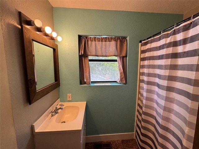 572 Eastern Ave, Bertram, TX 78605 - bathroom with vanity and a shower with shower curtain