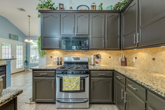 307 N Rainbow Bridge Dr, Cedar Park, TX 78613 - kitchen featuring stainless steel gas stove, black microwave, light stone counters, decorative backsplash, and light tile patterned floors