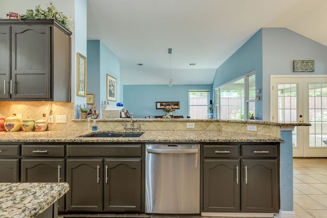 307 N Rainbow Bridge Dr, Cedar Park, TX 78613 - kitchen with stainless steel dishwasher, light tile patterned flooring, tasteful backsplash, and a peninsula