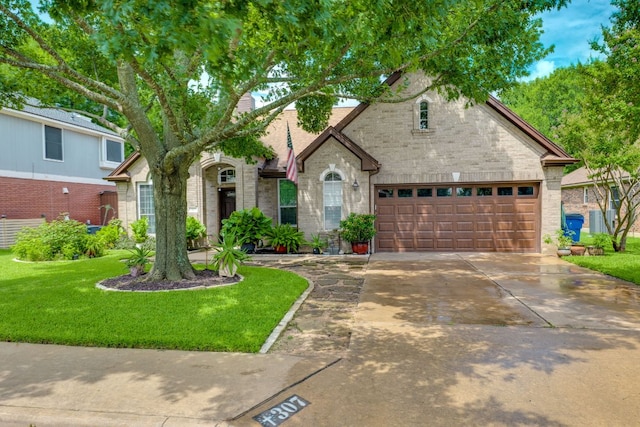 307 N Rainbow Bridge Dr, Cedar Park, TX 78613 - view of front of house with driveway, a front lawn, and brick siding