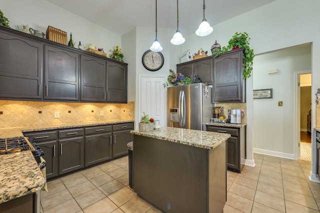 307 N Rainbow Bridge Dr, Cedar Park, TX 78613 - kitchen featuring stainless steel fridge with ice dispenser, light tile patterned flooring, light stone countertops, decorative backsplash, and a kitchen island