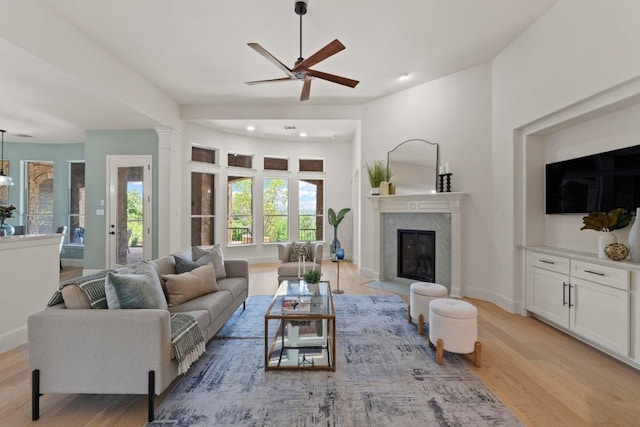 908 Lakewood Hills Ter, Austin, TX 78732 - living area featuring light wood finished floors, ceiling fan, a fireplace, recessed lighting, and ornate columns