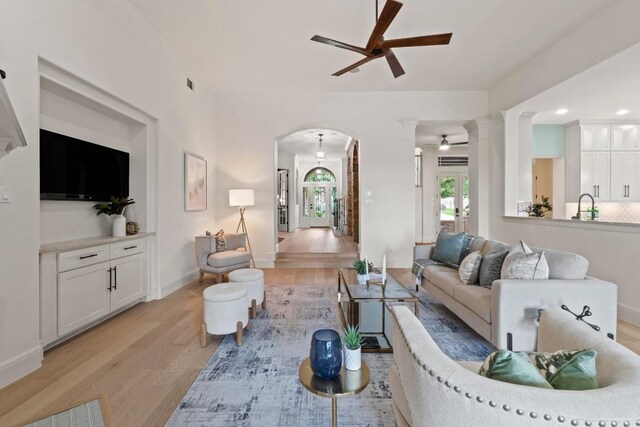 908 Lakewood Hills Ter, Austin, TX 78732 - living area with a ceiling fan, light wood-style flooring, arched walkways, decorative columns, and recessed lighting